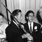 Retired aviator Nobuo Fujita presents his family’s 400-year-old sword to Brookings Mayor Fell Campbell as his wife, Ayako, and son, Yasuyoshi, look on. (Image: William McCash/ Bombs Over Brookings book) 