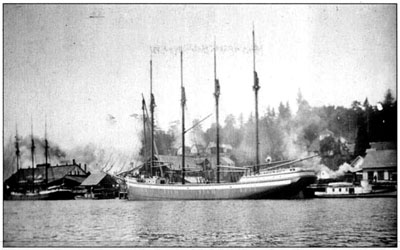 Four-masted schooner Admiral in its home port of North Bend, taking on a cargo of lumber.