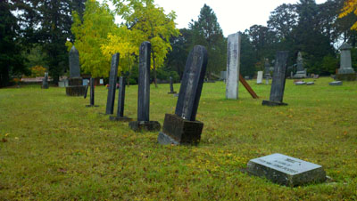 The John A. Porter family of grave markers, in the Odd Fellows  Cemetery in Corvallis, Ore. From near to far, the markers are for Ame; the younger Mary Porter; the elder Mary Porter; Elsie Porter; and John Porter.